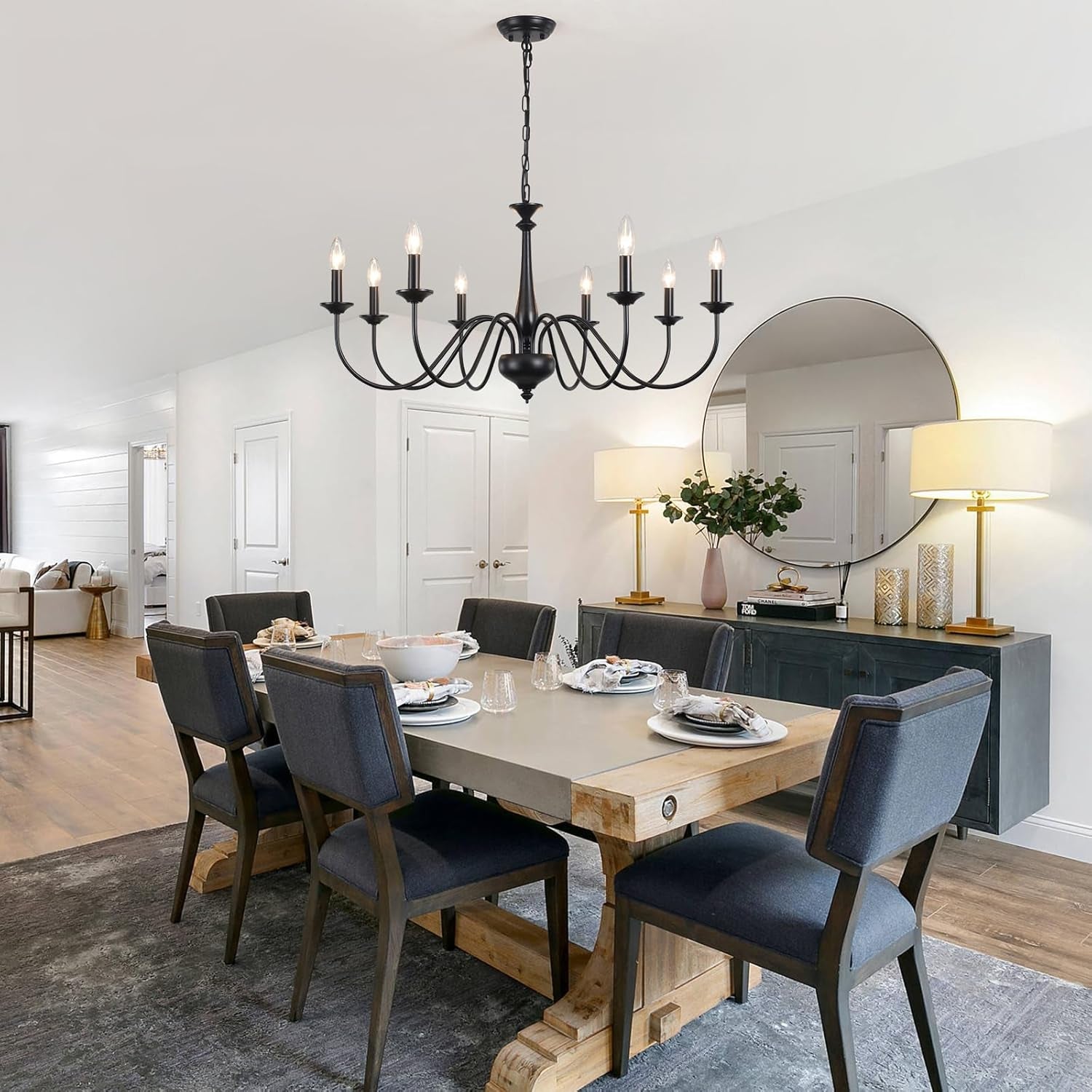 Dining room with wooden table, gray chairs, and a chandelier.