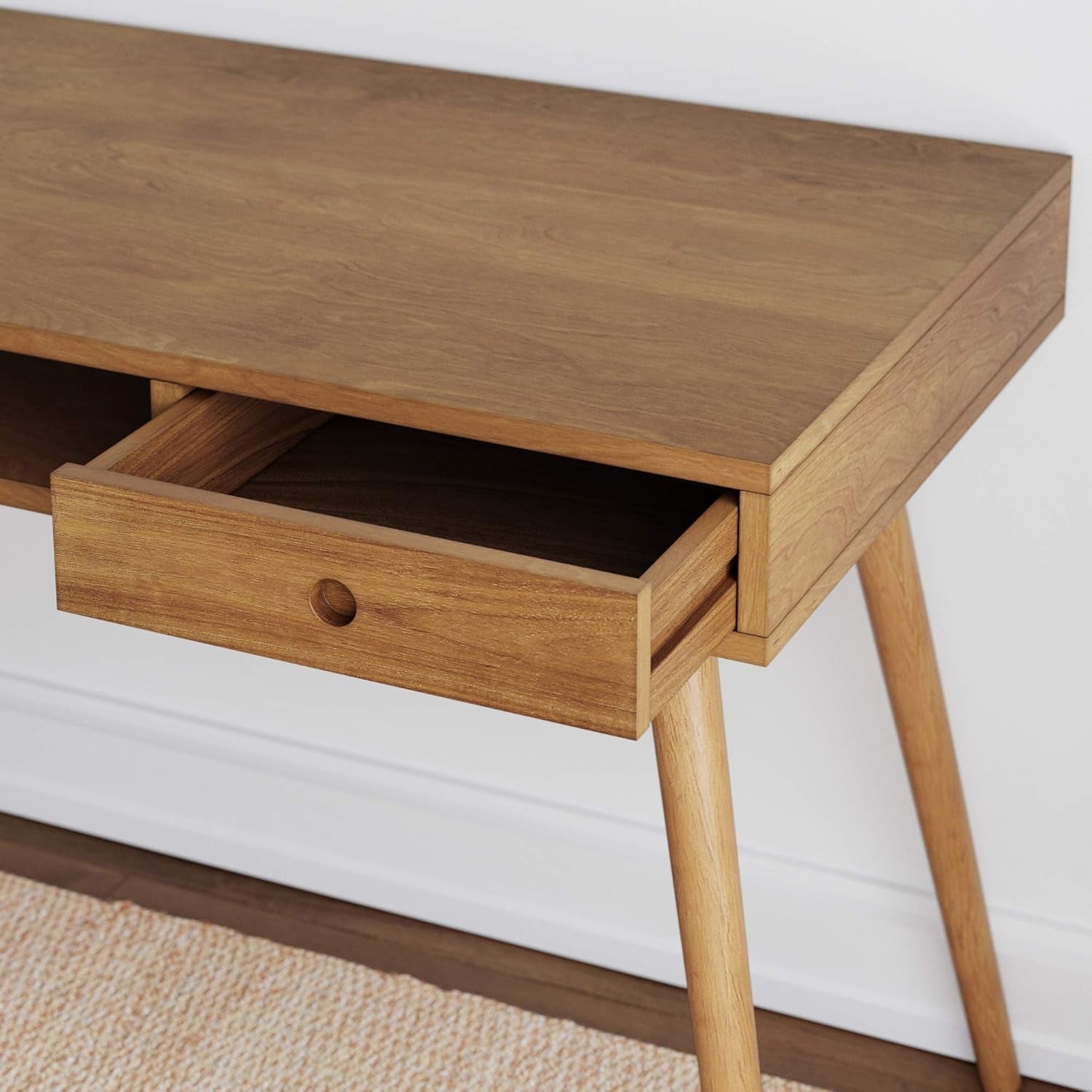 Wooden desk with a single drawer on a white background