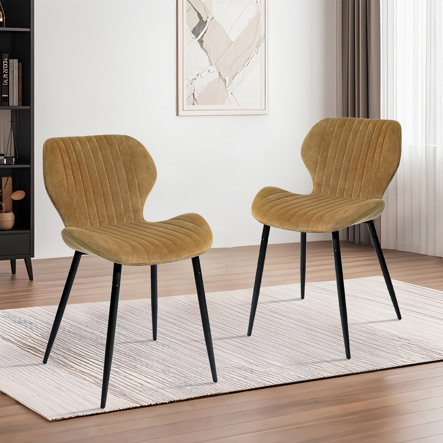 Two brown chairs with black legs on a wooden floor in a room.