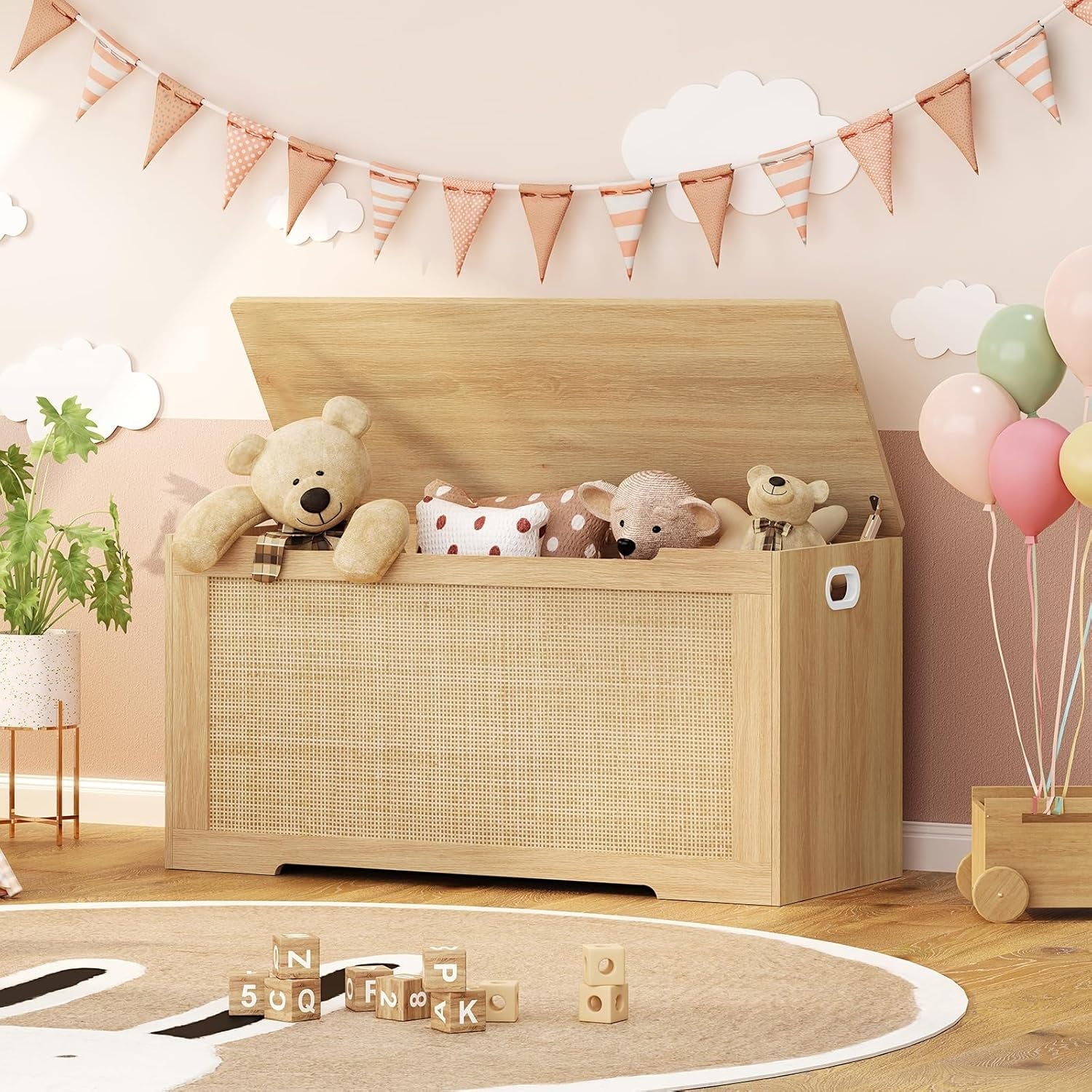 Wooden toy chest filled with stuffed animals in a child's room with balloons and flags.