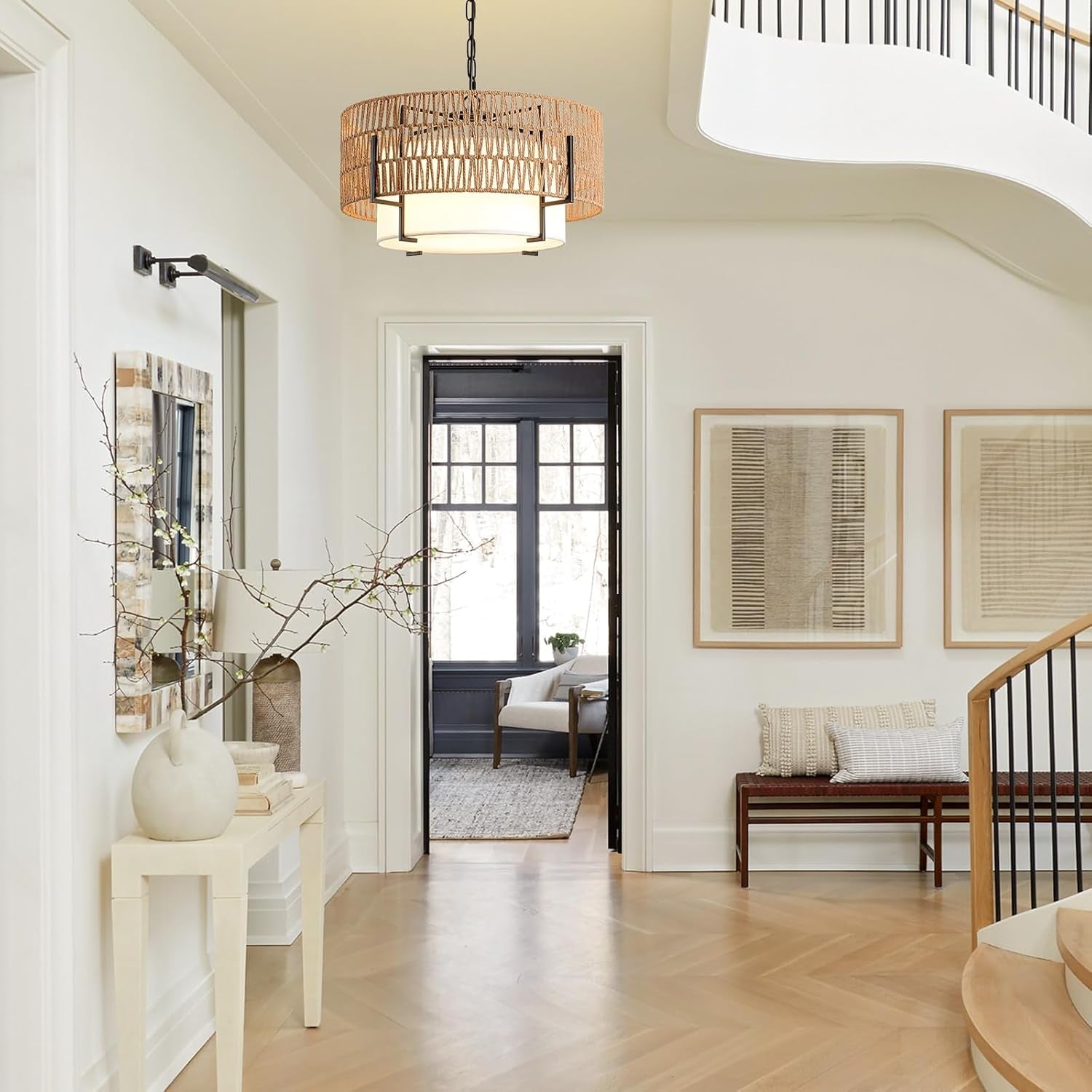 Modern interior of a home with a staircase, light fixture, and decor elements.