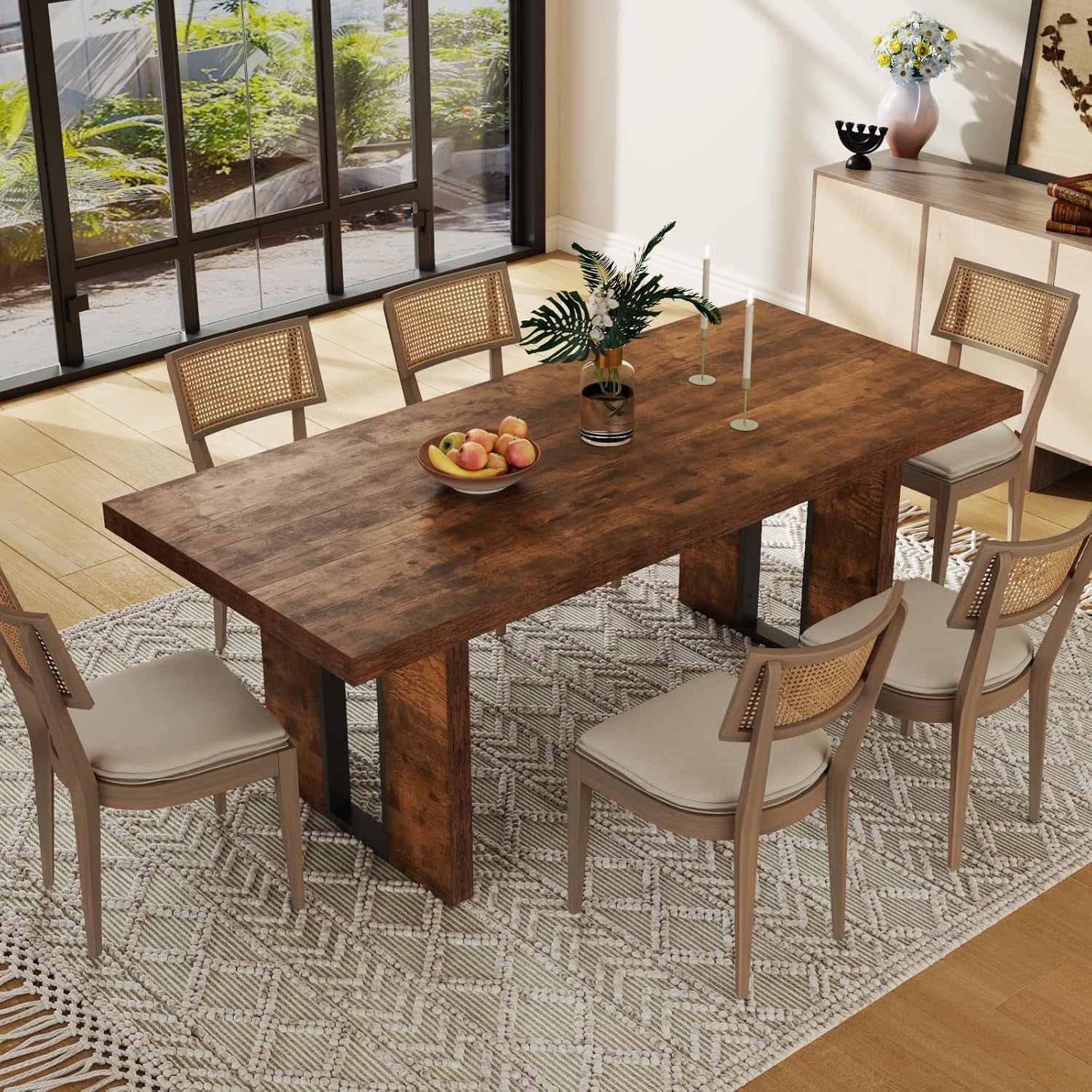 Dining room with a wooden table and chairs on a patterned rug.