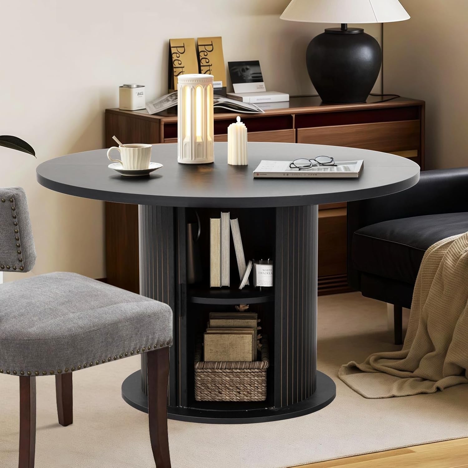 Round black table with storage shelves in a home office setting