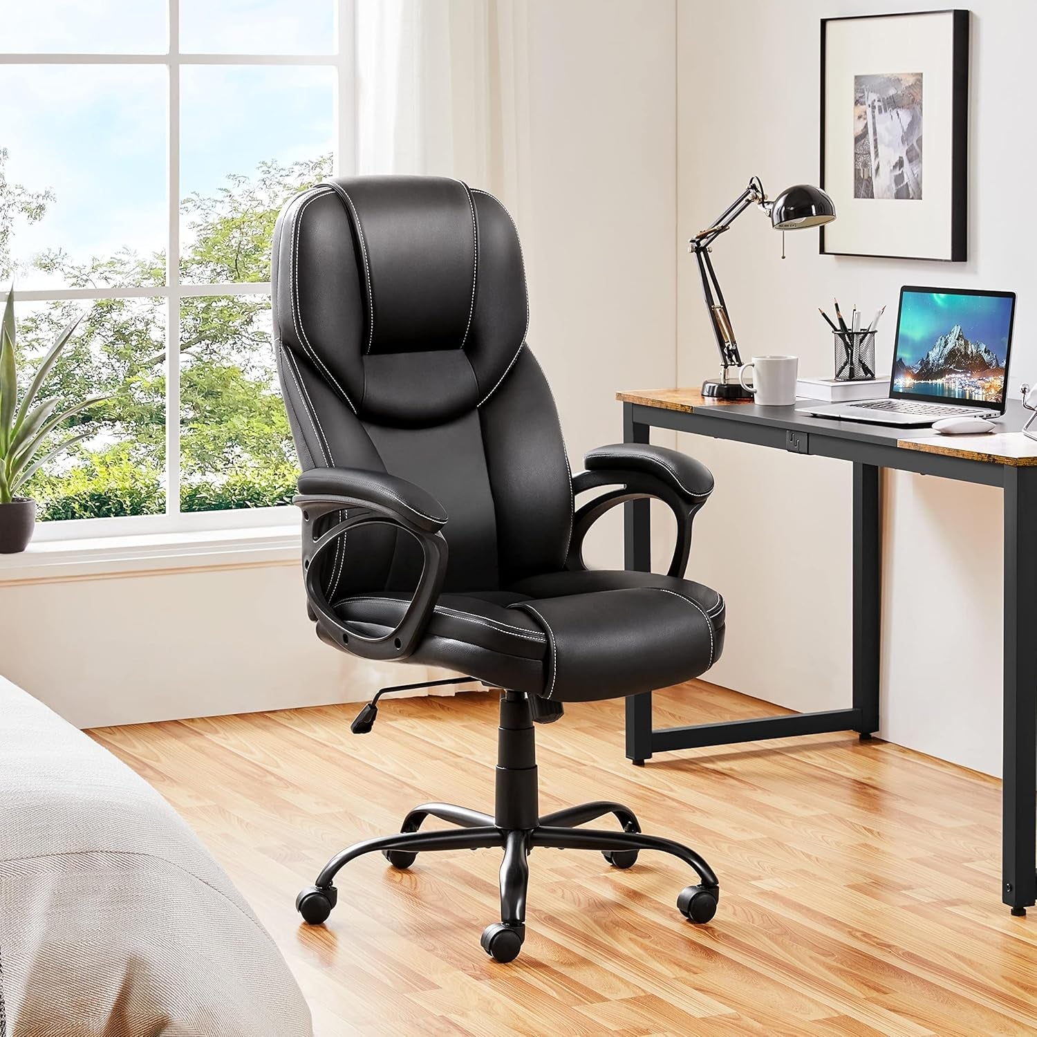 Black office chair in a home office setting with a desk and computer.