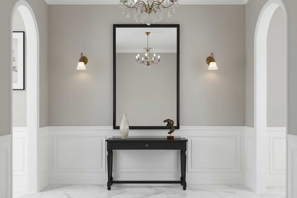 Living room with a white sofa, decorative pillows, and a large mirror on the wall.