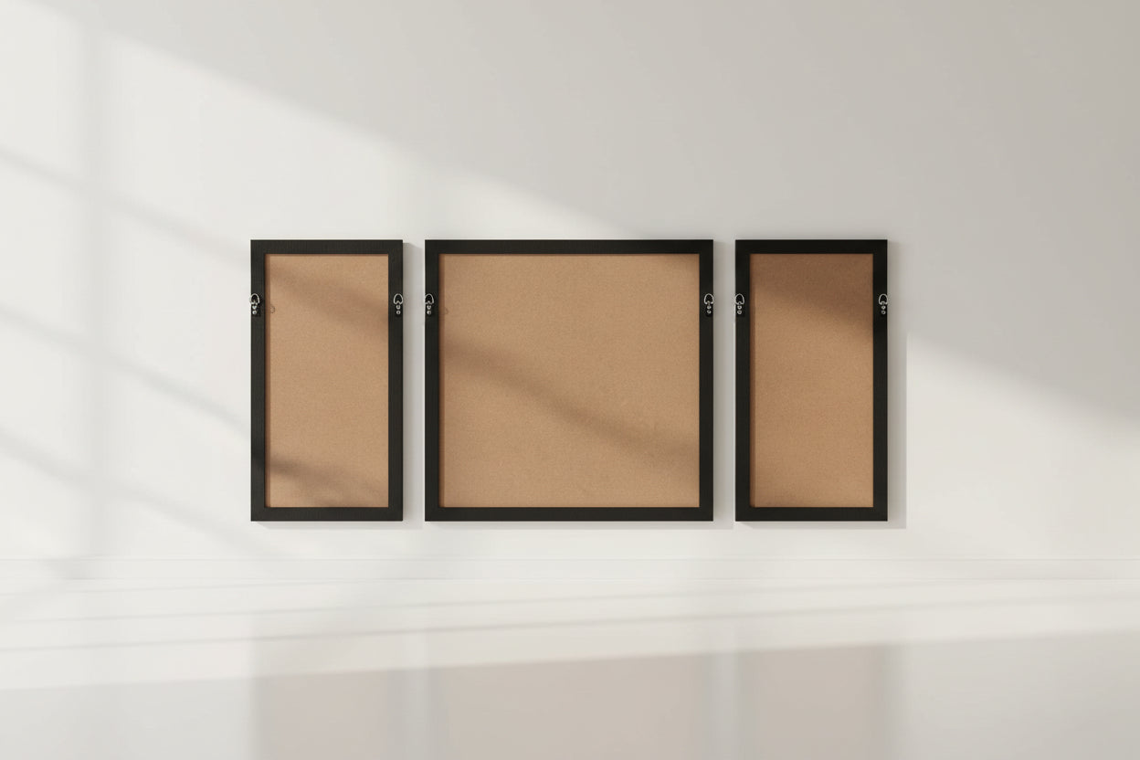Three cork bulletin boards with black frames on a white background