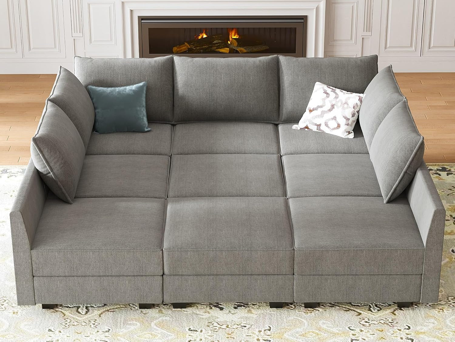 Gray sectional sofa with cushions in a living room setting.