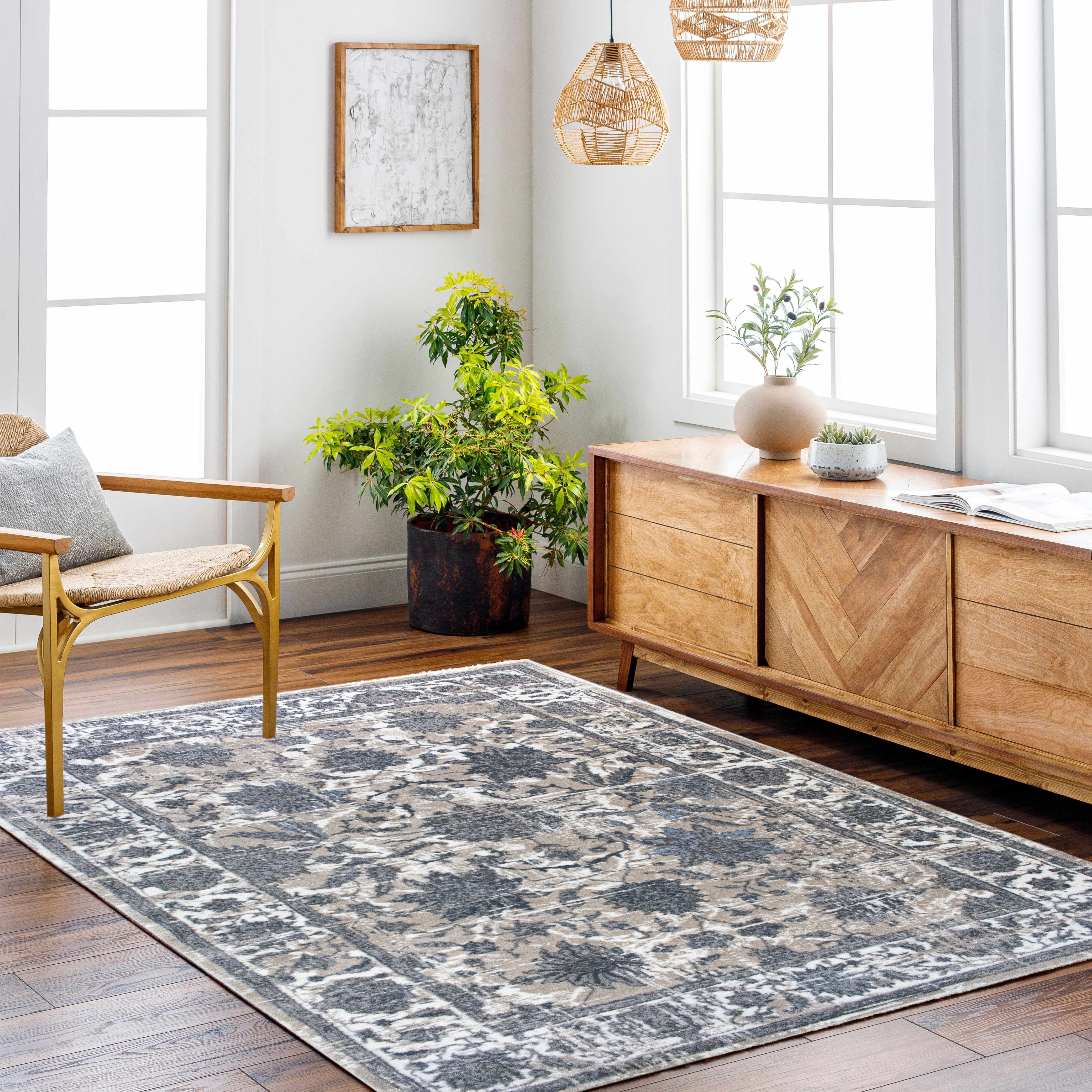 Living room with a patterned rug, wooden chair, and sideboard.