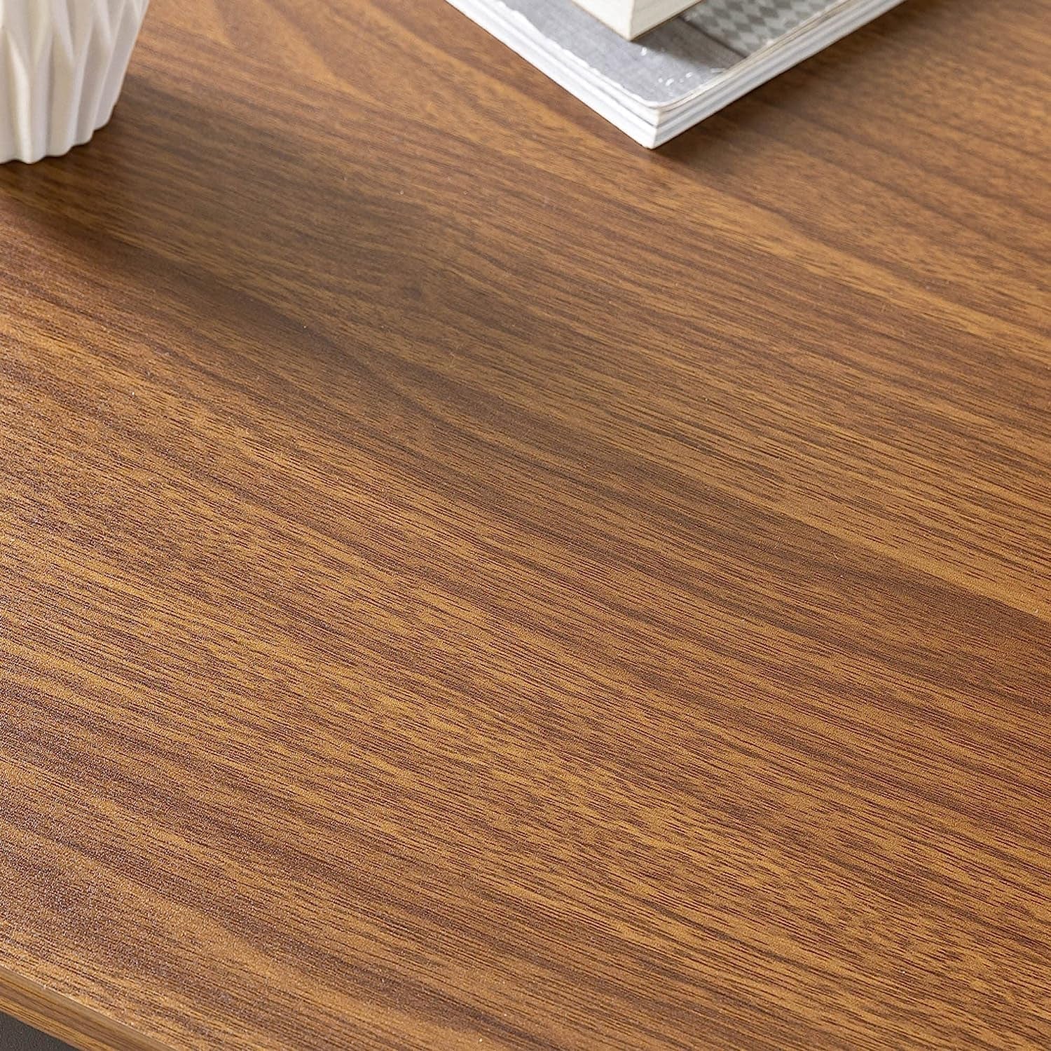 Close-up of a wooden desk surface with a keyboard partially visible.