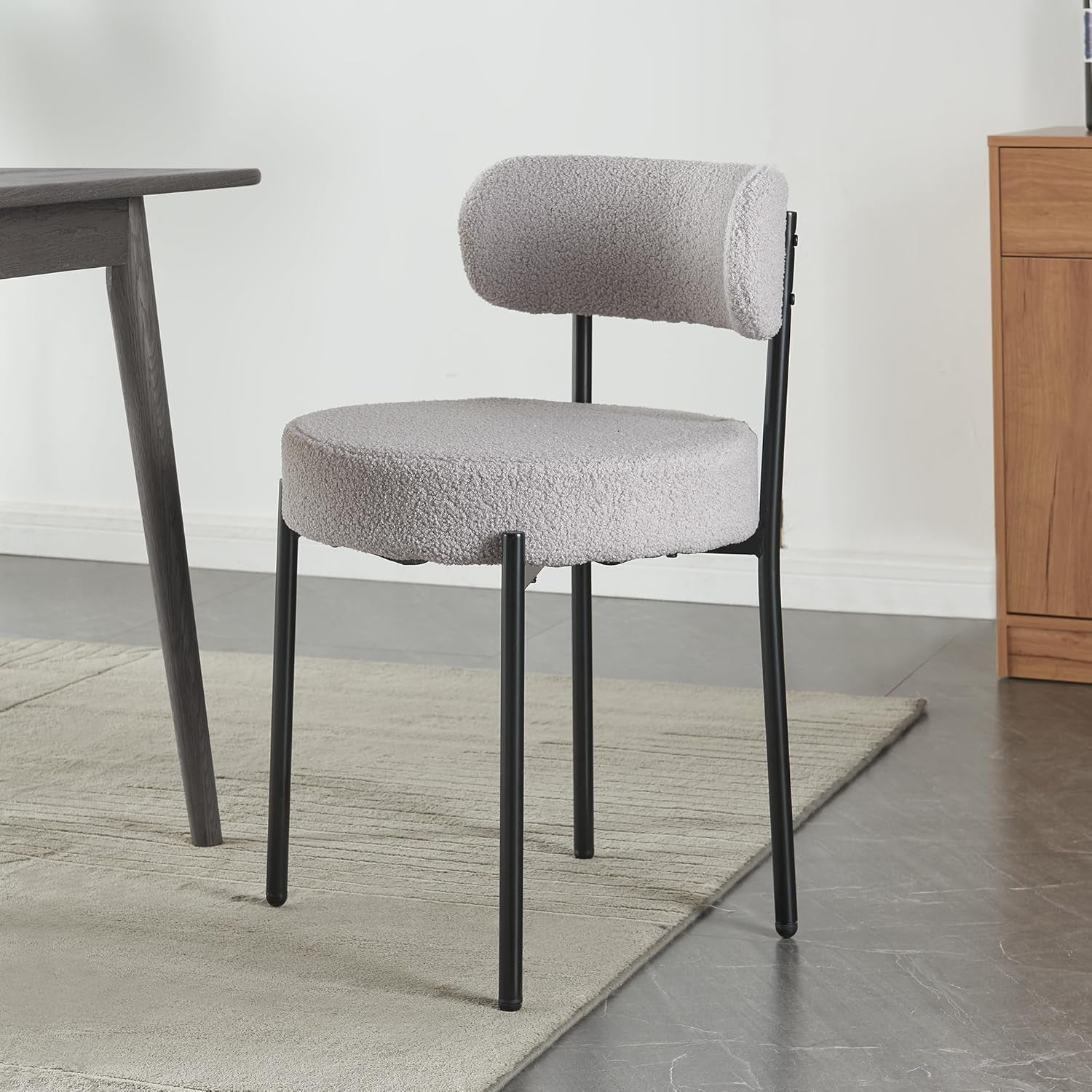 Gray upholstered chair with black legs in a room setting