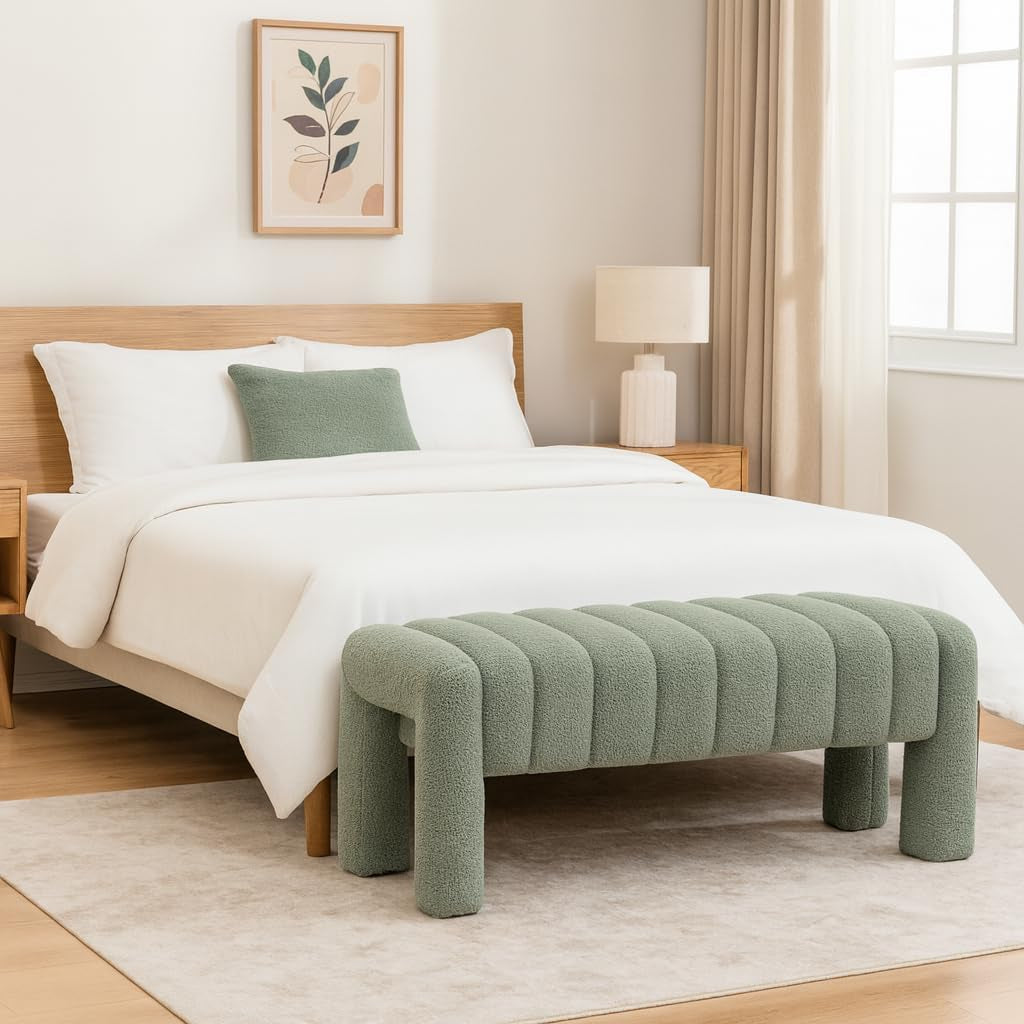 Green upholstered bench in front of a bed with white bedding in a bedroom setting.