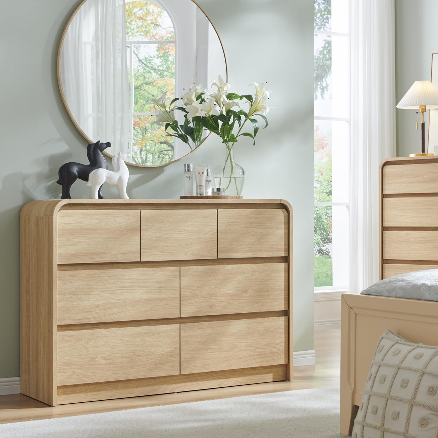 Wooden dresser with decorative items in a bedroom setting