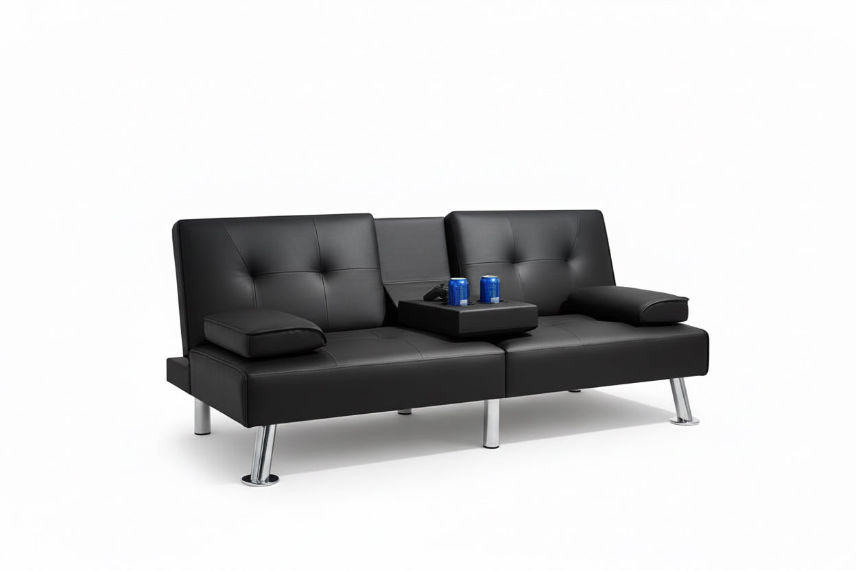 Black leather sofa in a modern room with gaming setup and shelves.