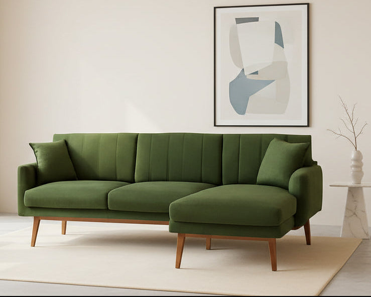 Green sectional sofa in a room with a neutral color scheme