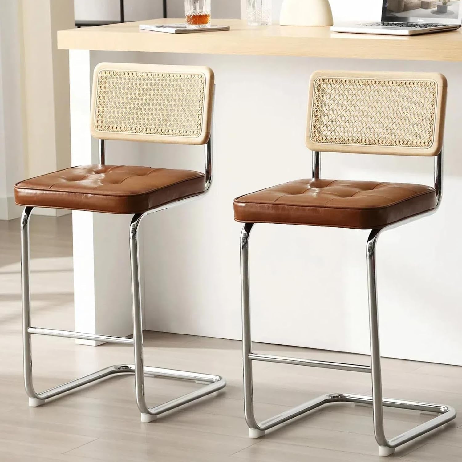 Two bar stools with woven backrests and brown seats in a kitchen setting.