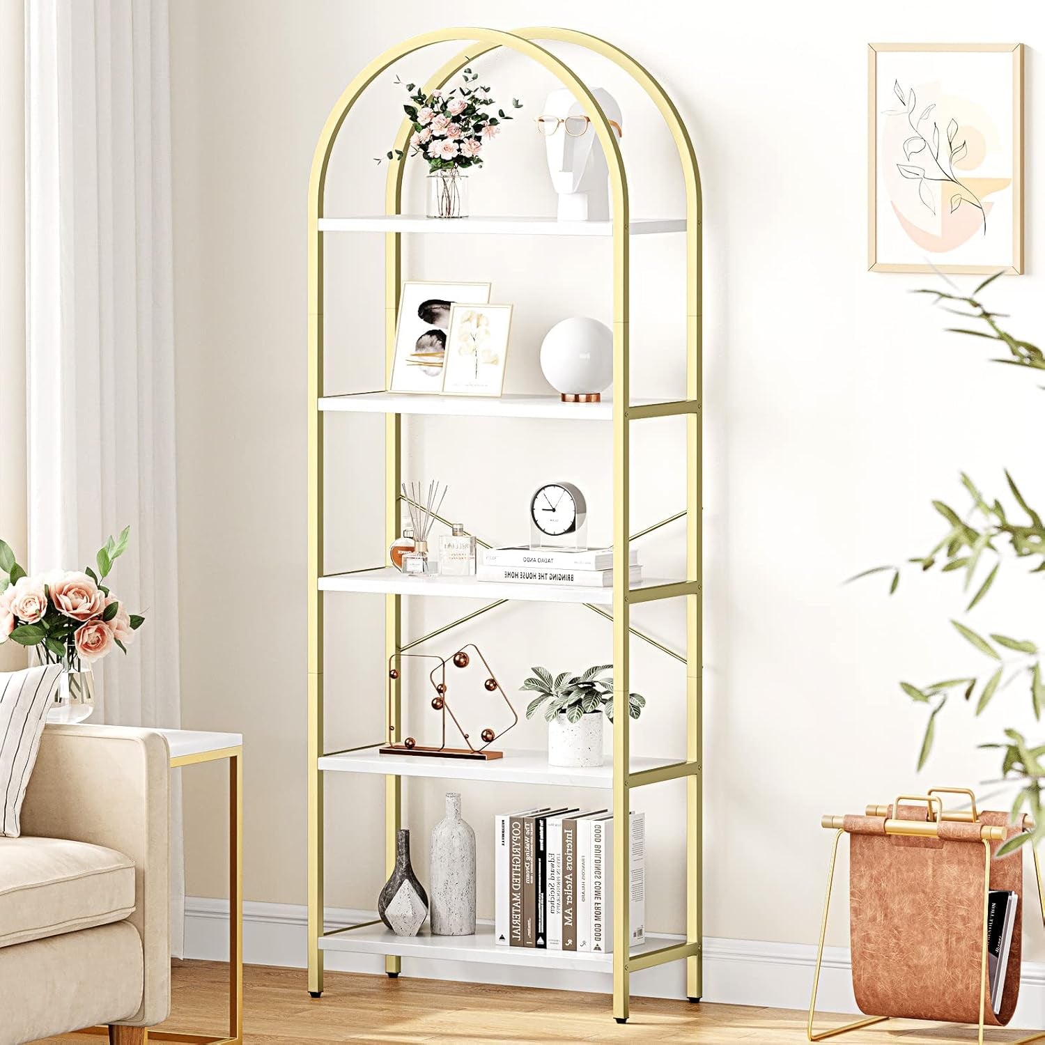 Gold arch-shaped bookshelf in a room with decor items and plants.