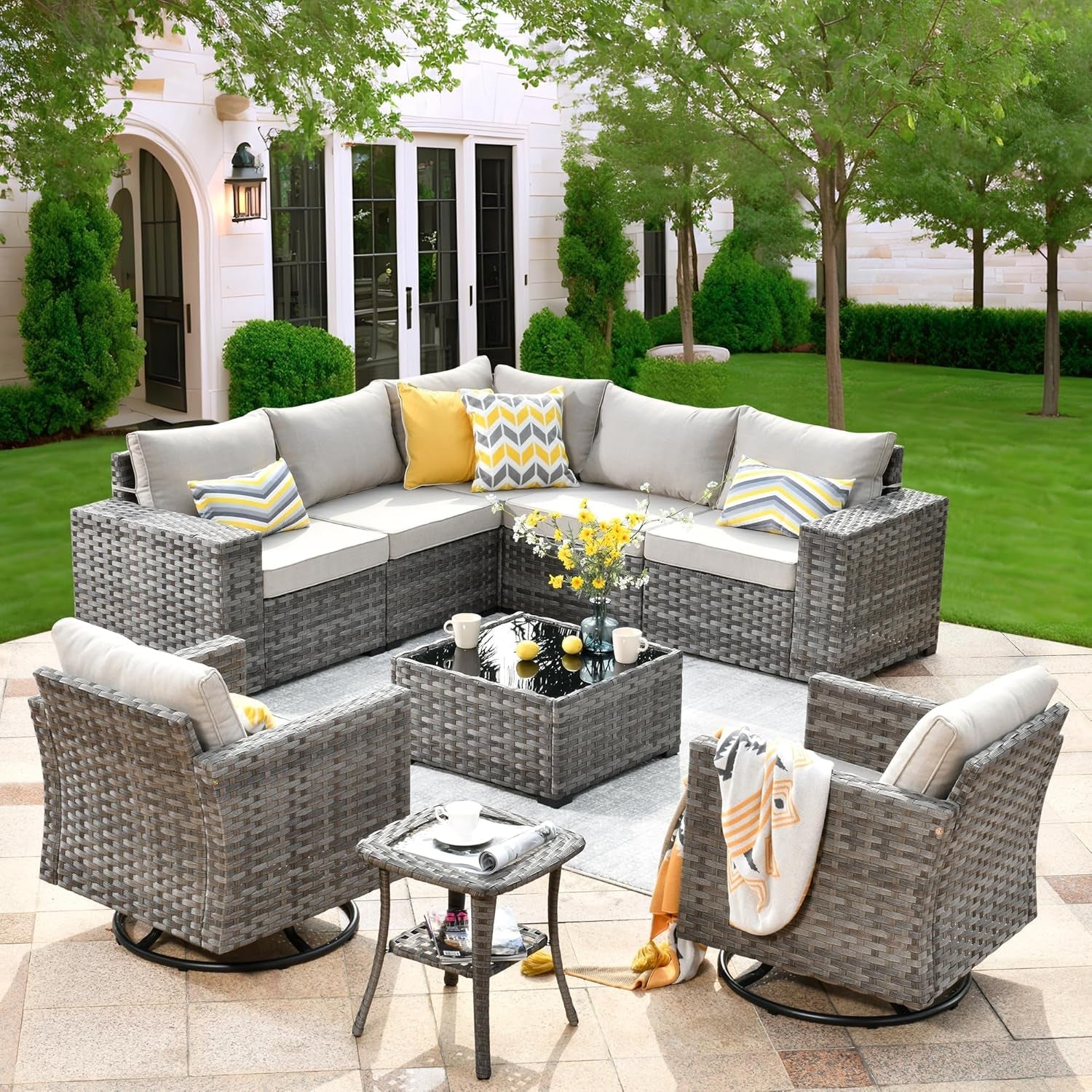 Outdoor patio furniture set with cushions on a patio area.