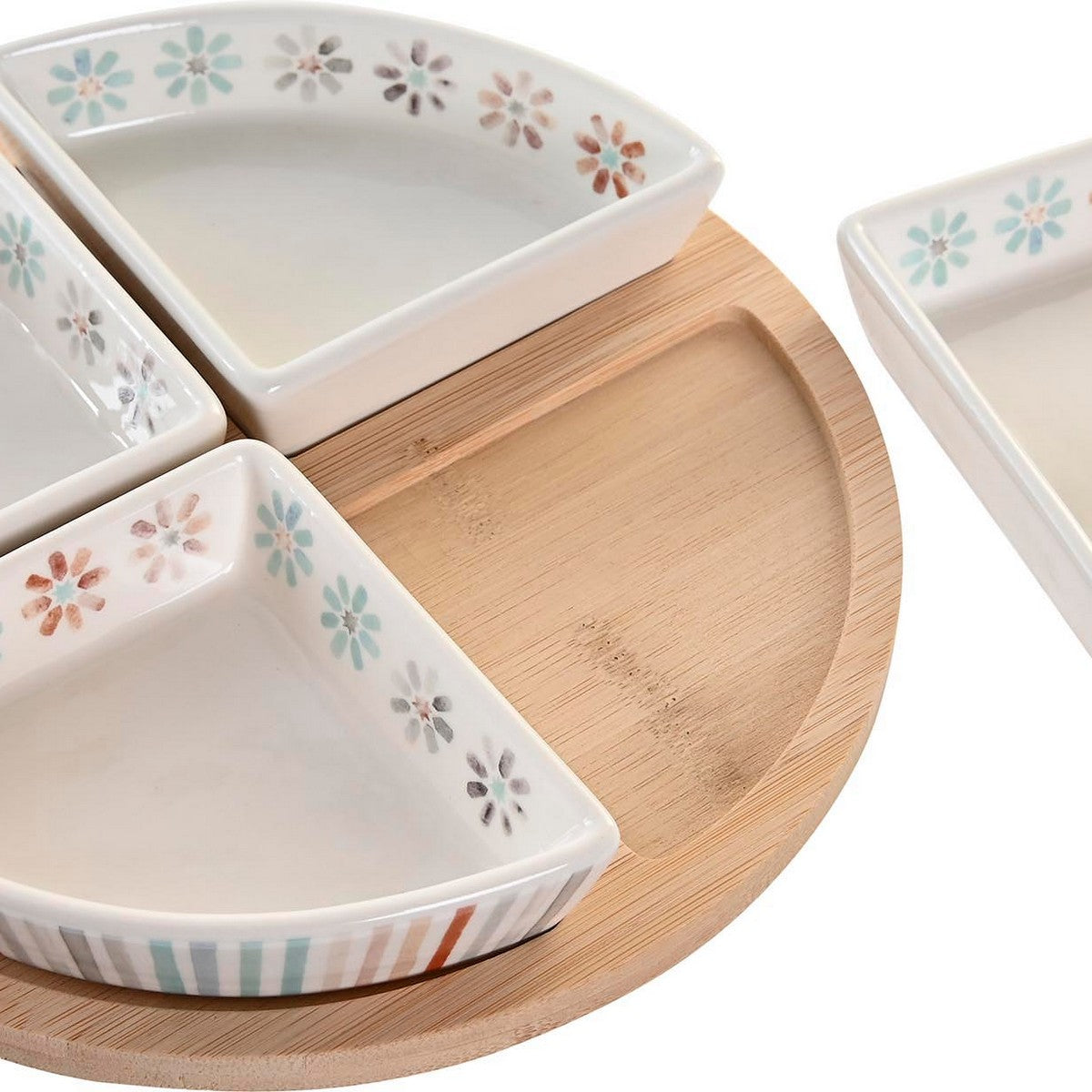 Set of ceramic triangular dishes with floral patterns on a wooden tray
