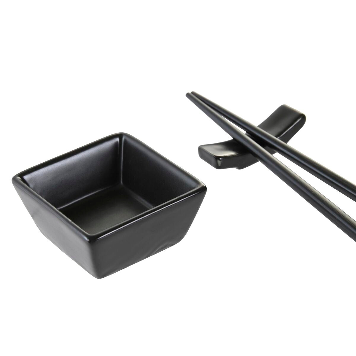 Black square bowl and chopsticks on a white background