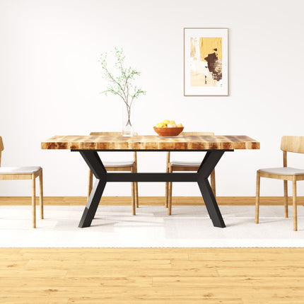 Dining table with wooden surface and black metal legs in a room with chairs and a painting on the wall.