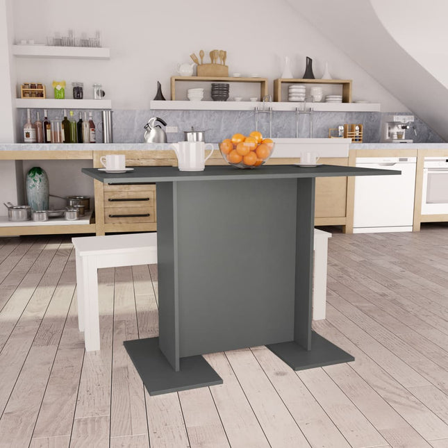 Modern kitchen with a gray island and wooden flooring.