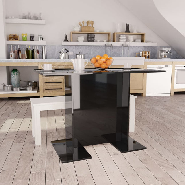 Modern kitchen with a black island and wooden flooring