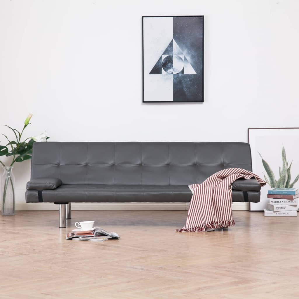 Gray sofa in a living room with a modern painting on the wall.