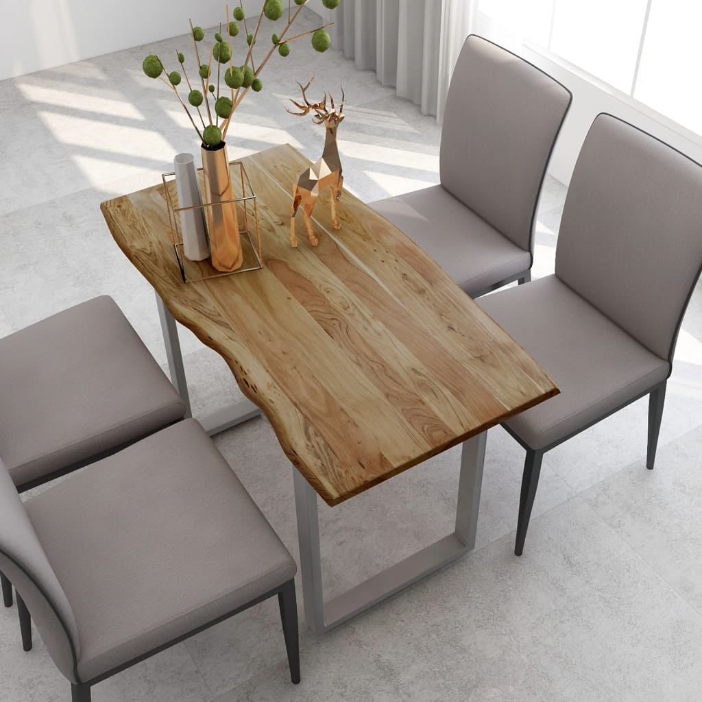 Dining table with natural wood finish and gray chairs in a modern interior setting.