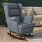 Gray upholstered rocking chair in a living room setting with a beige sofa and wooden floor.