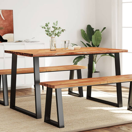 Dining table with benches in a room with plants and decor