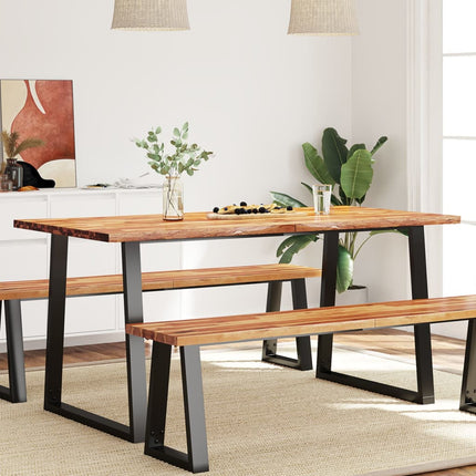 Dining table with benches in a room with plants and decor