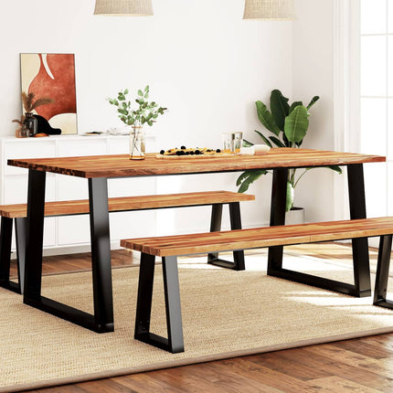 Wooden dining table with benches in a modern living room setting.
