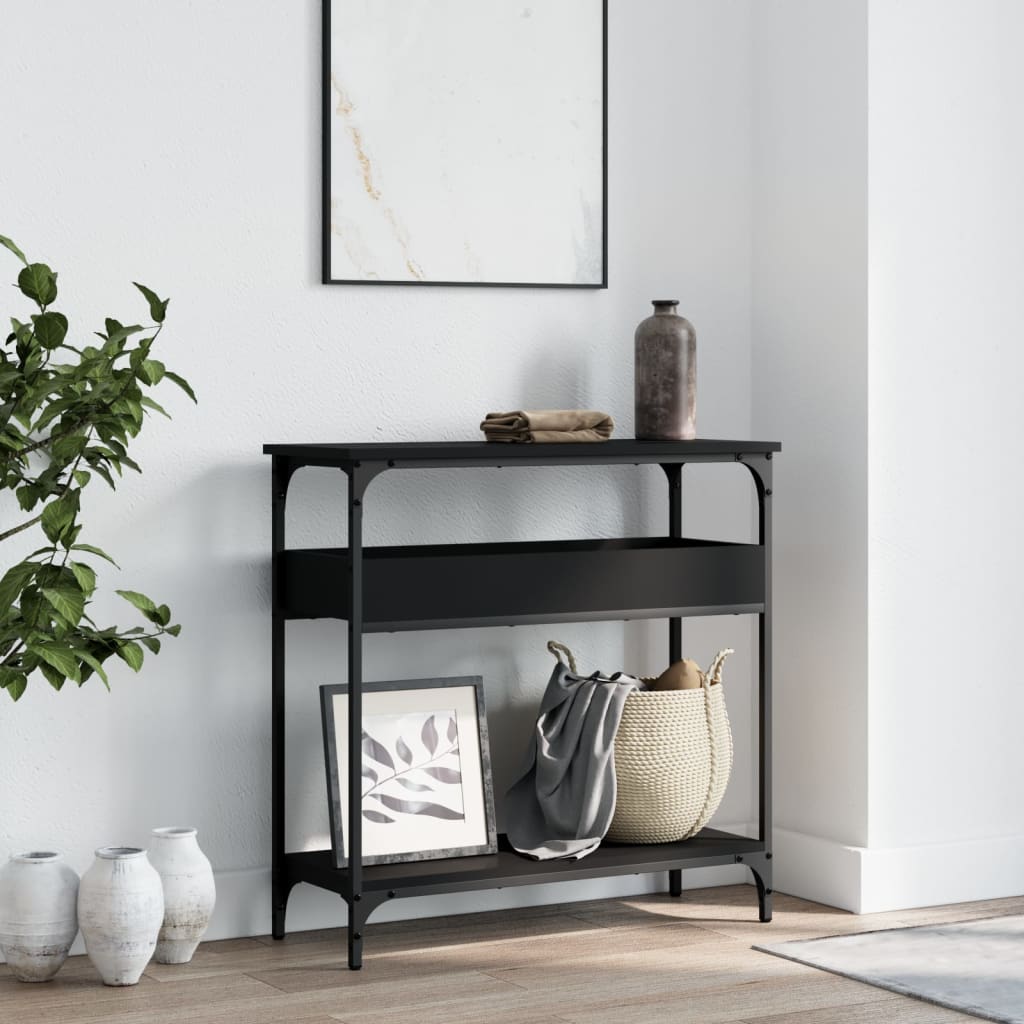Black metal console table with decorative items in a room setting.