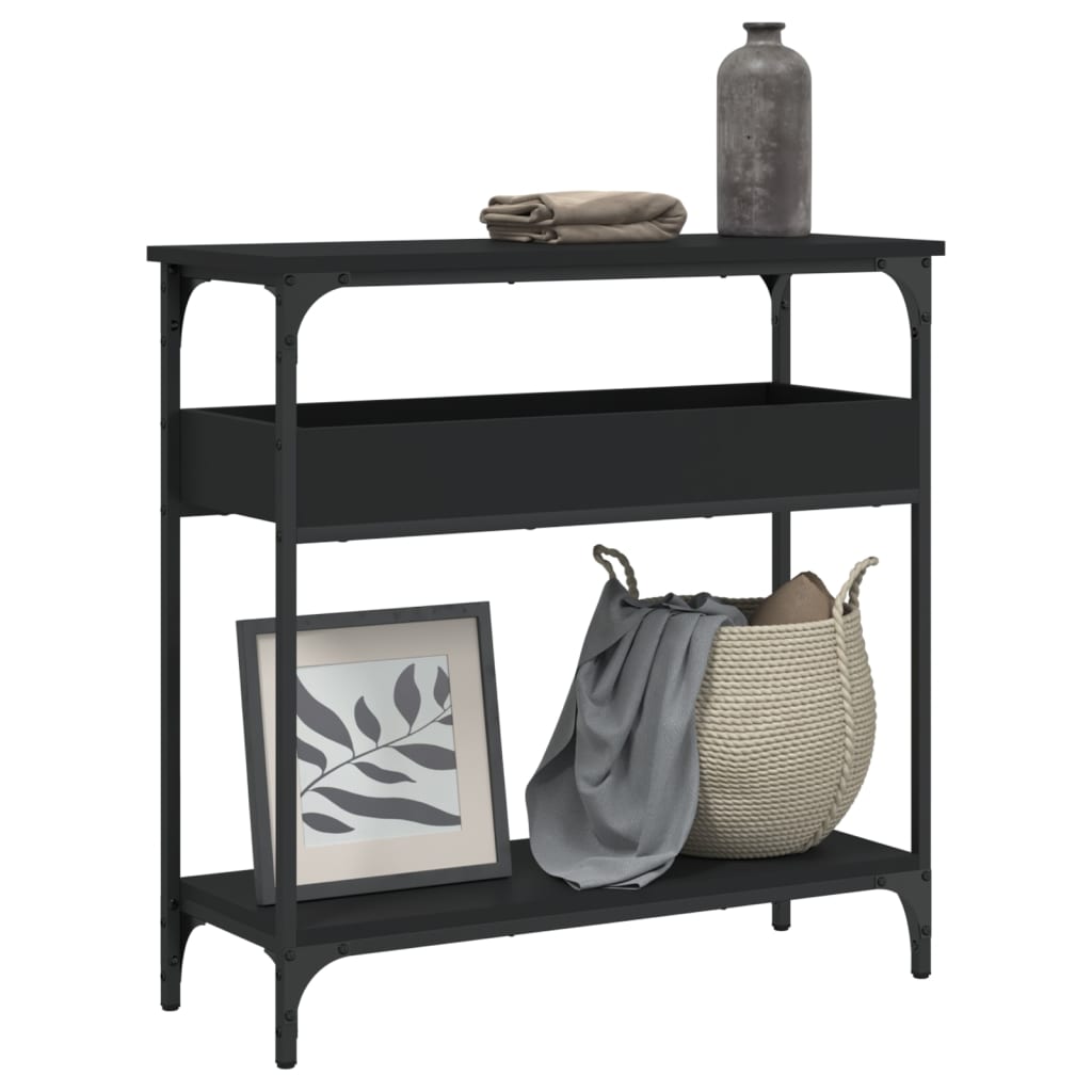 Black metal console table with decorative items on a white background
