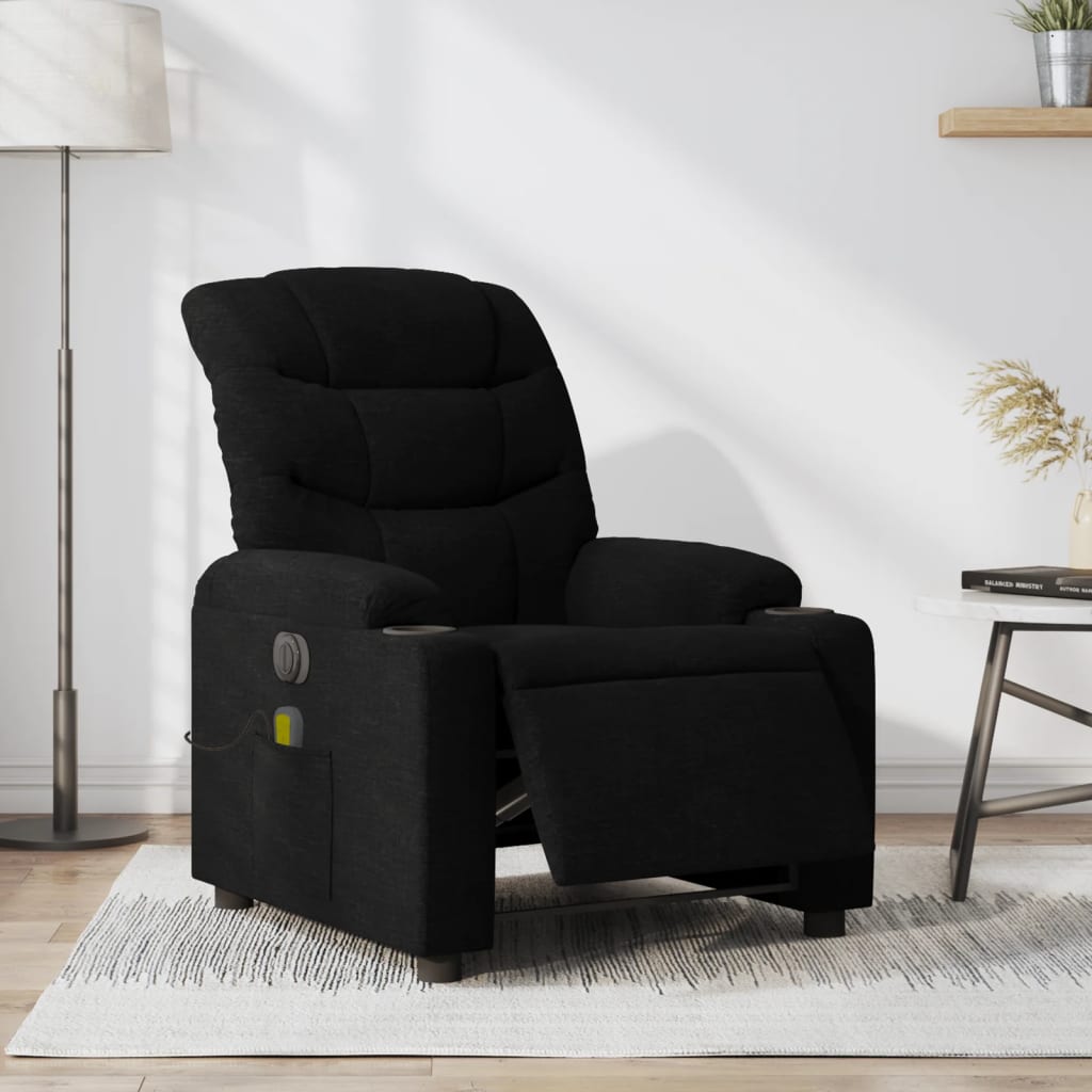 Black recliner chair in a living room setting with a lamp and table in the background.