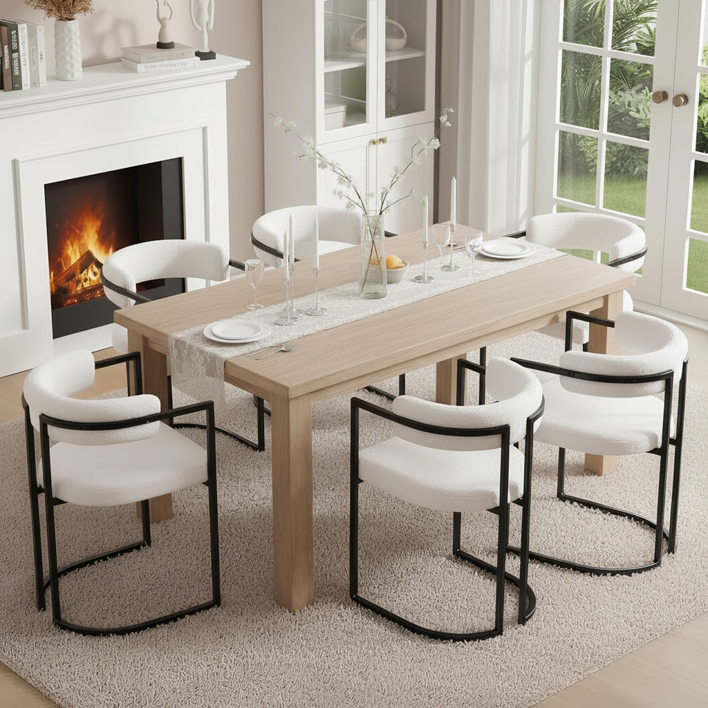 Family of five sitting around a dining table in a cozy living room with a fireplace.