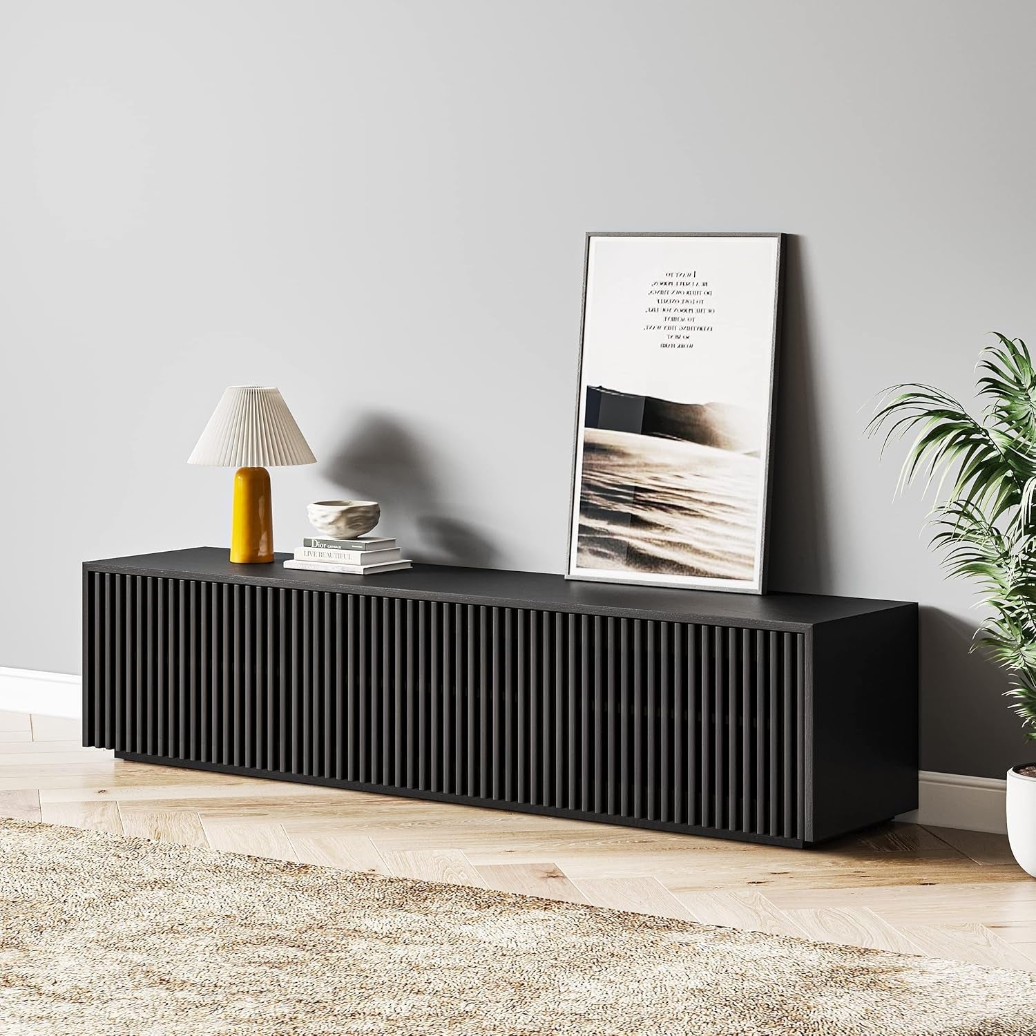 Black console table with decorative items against a gray wall