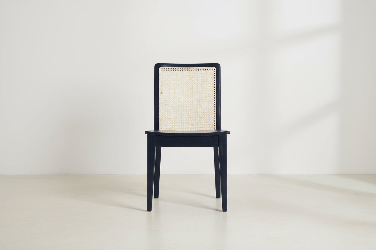 Black wooden chair with woven backrest on a white background