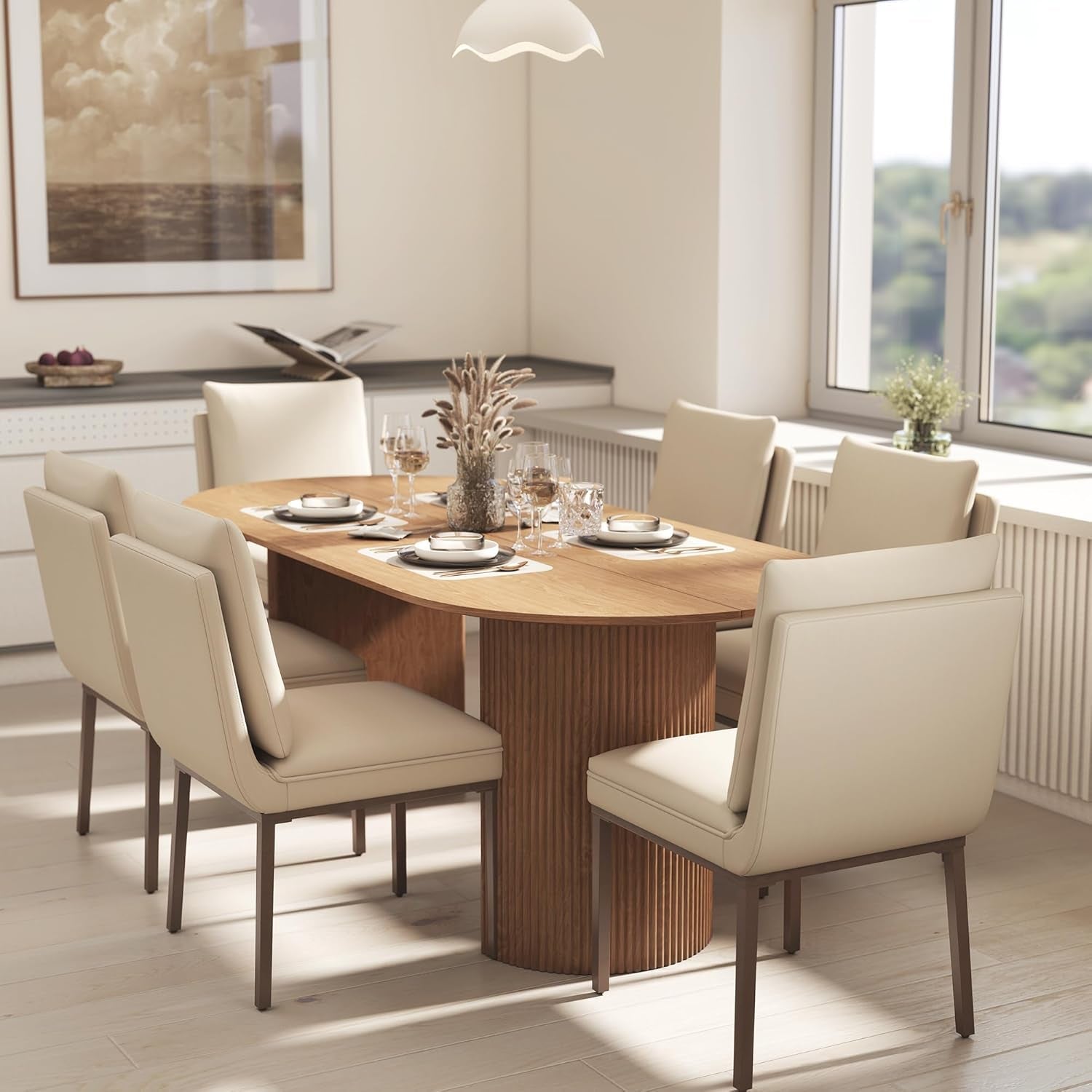 Dining room with a wooden table and beige chairs, featuring a large window with a view of greenery.