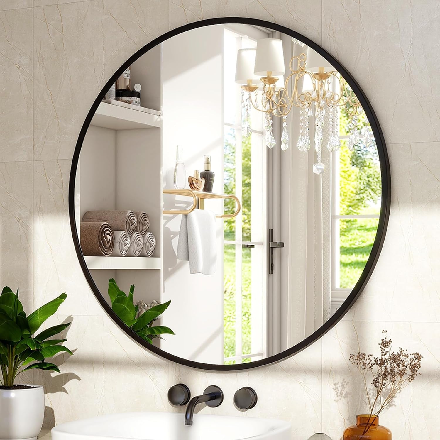Round black-framed mirror in a bathroom with a view of a garden.
