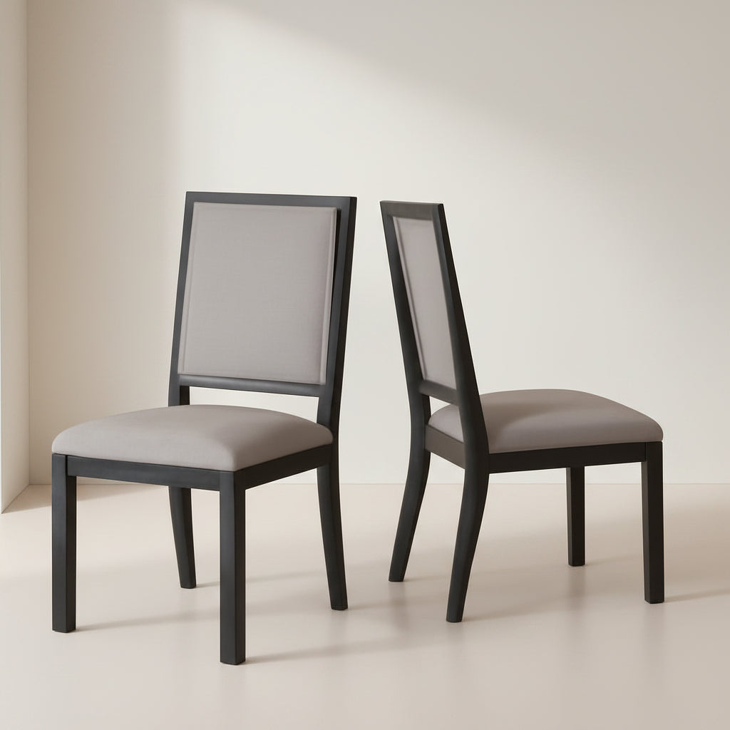 Two gray upholstered chairs with dark wooden frames on a beige floor.