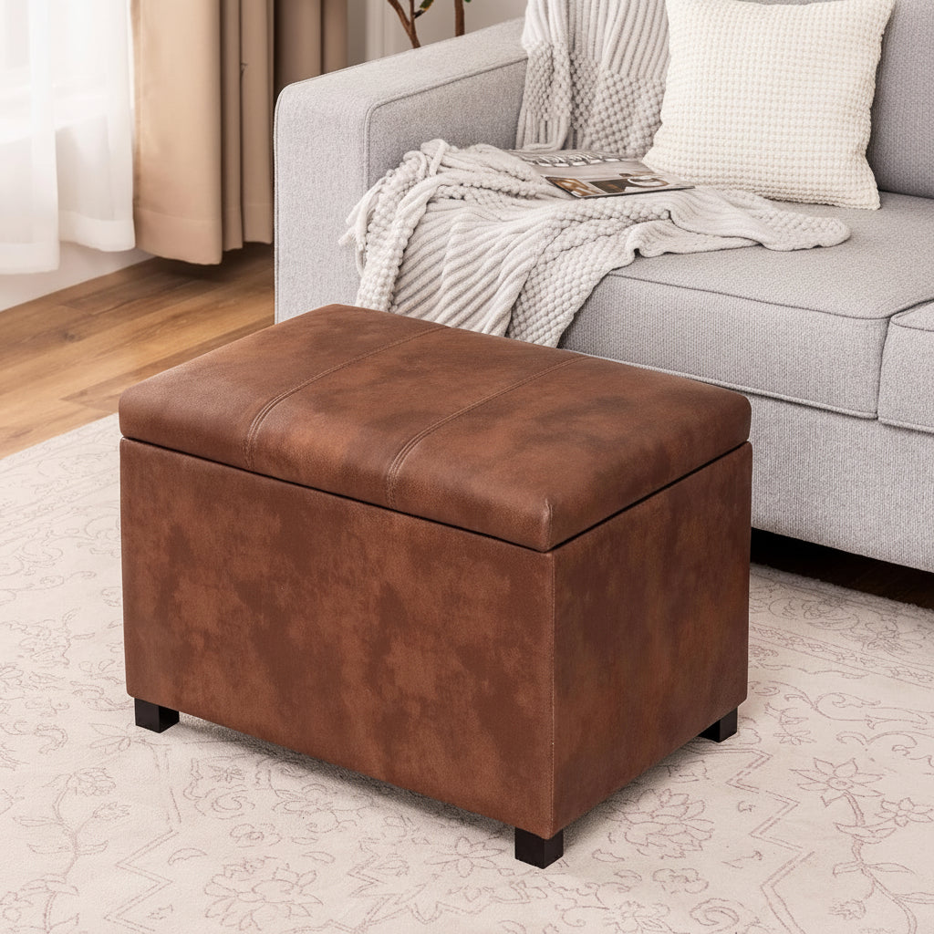 Brown storage ottoman in a living room setting with a person reading a magazine on a gray sofa.