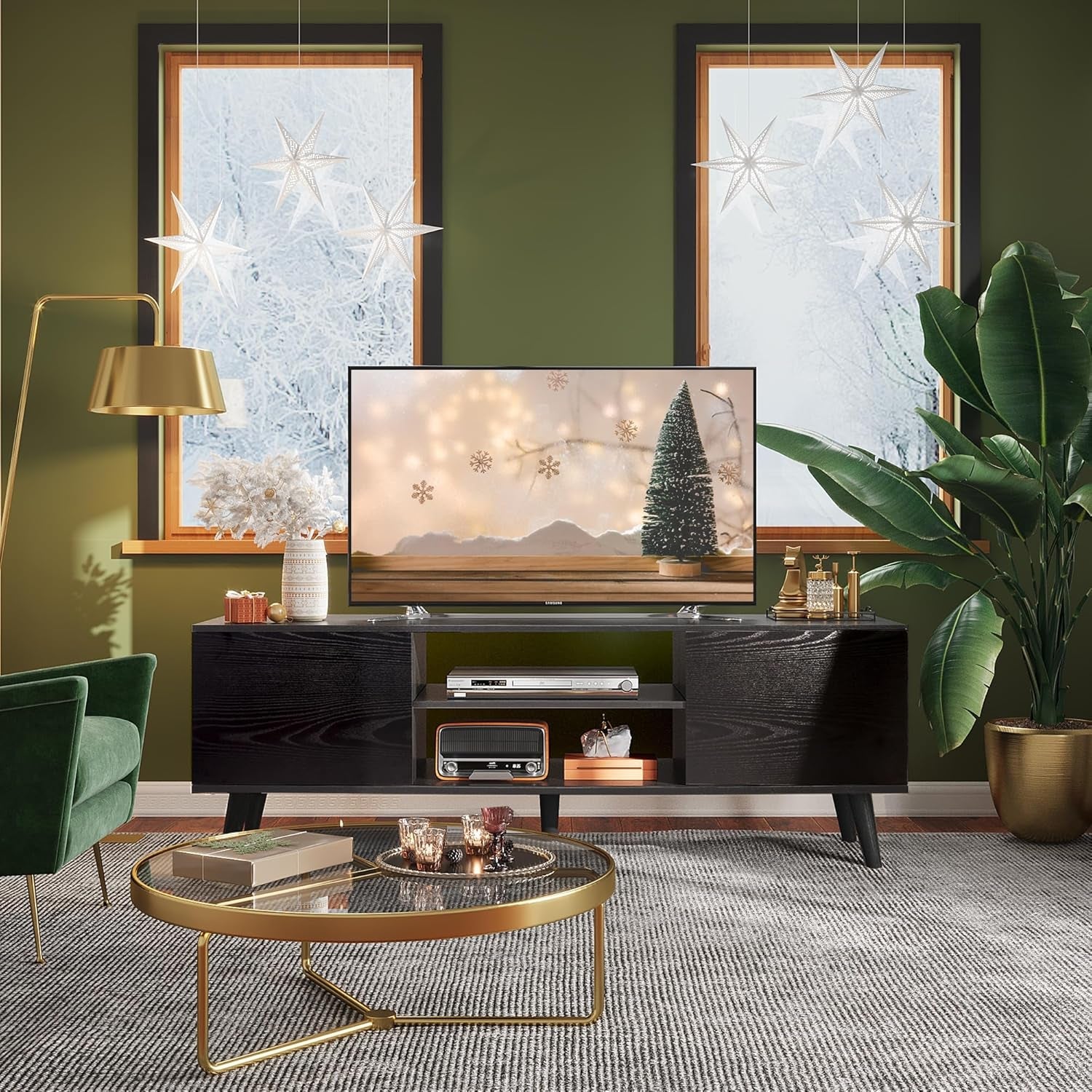 Modern living room with a TV on a stand, green walls, and decorative elements.