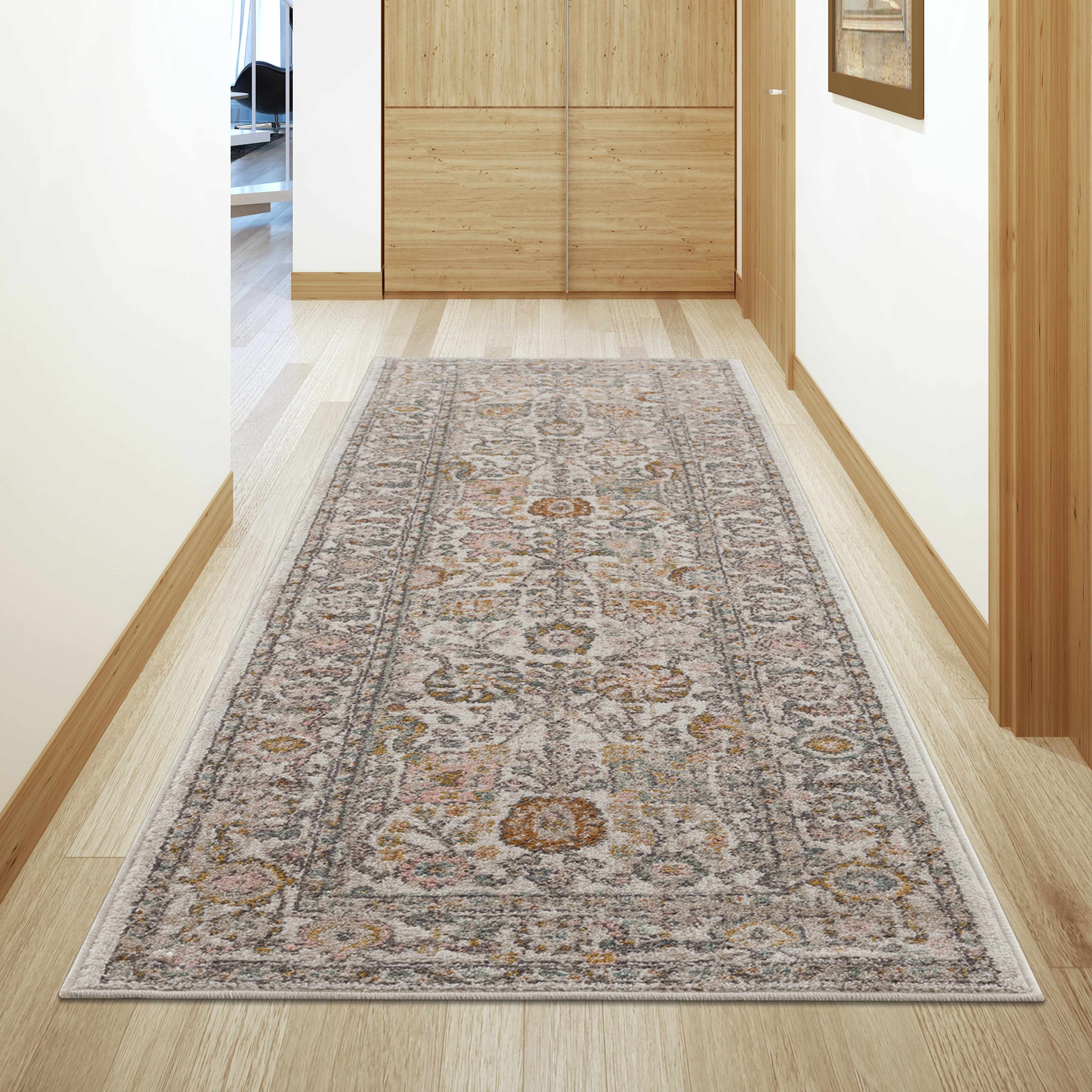 Decorative rug on a wooden floor in a room with light-colored walls.
