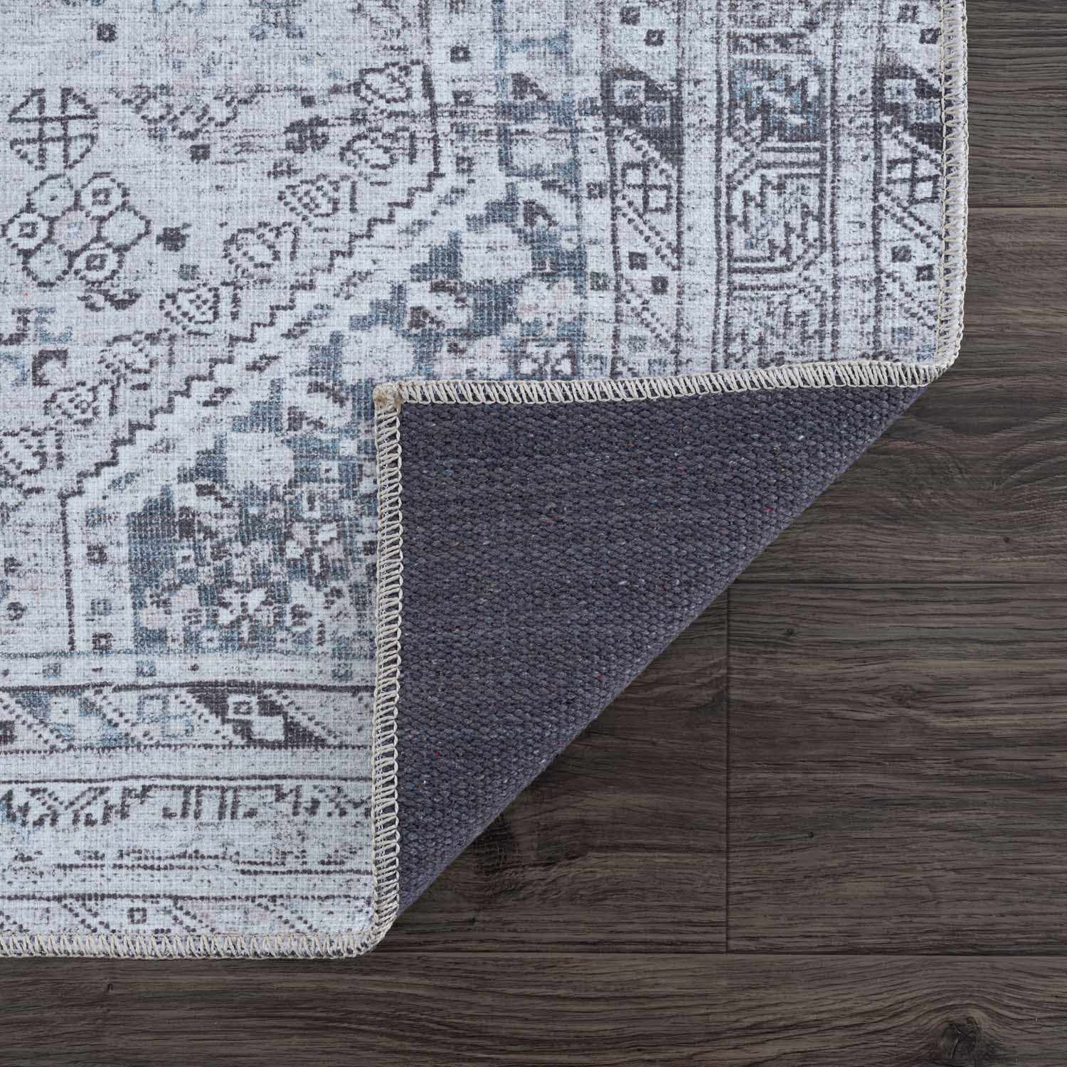 Patterned rug on a wooden floor