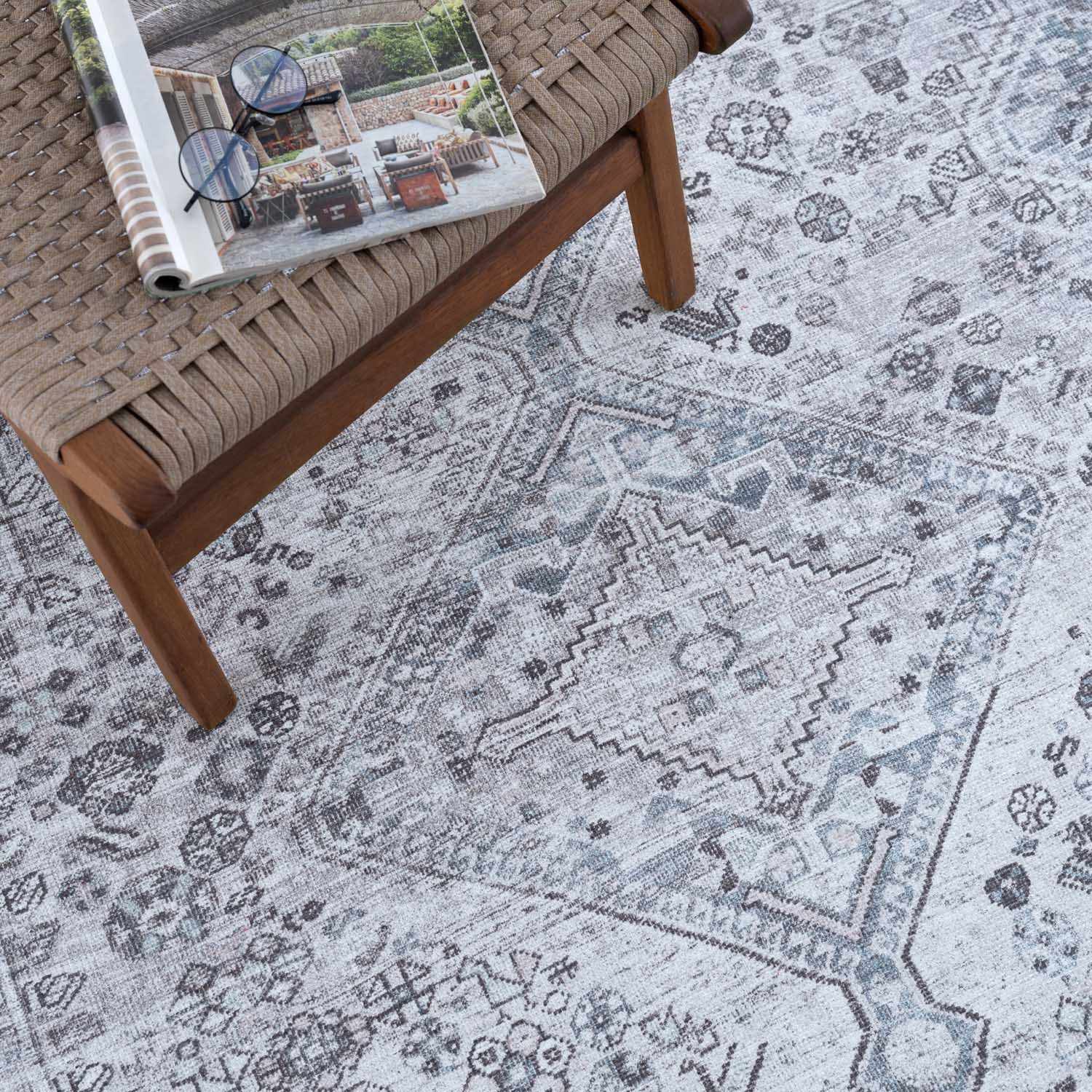 Patterned rug with a wooden bench and magazine on top