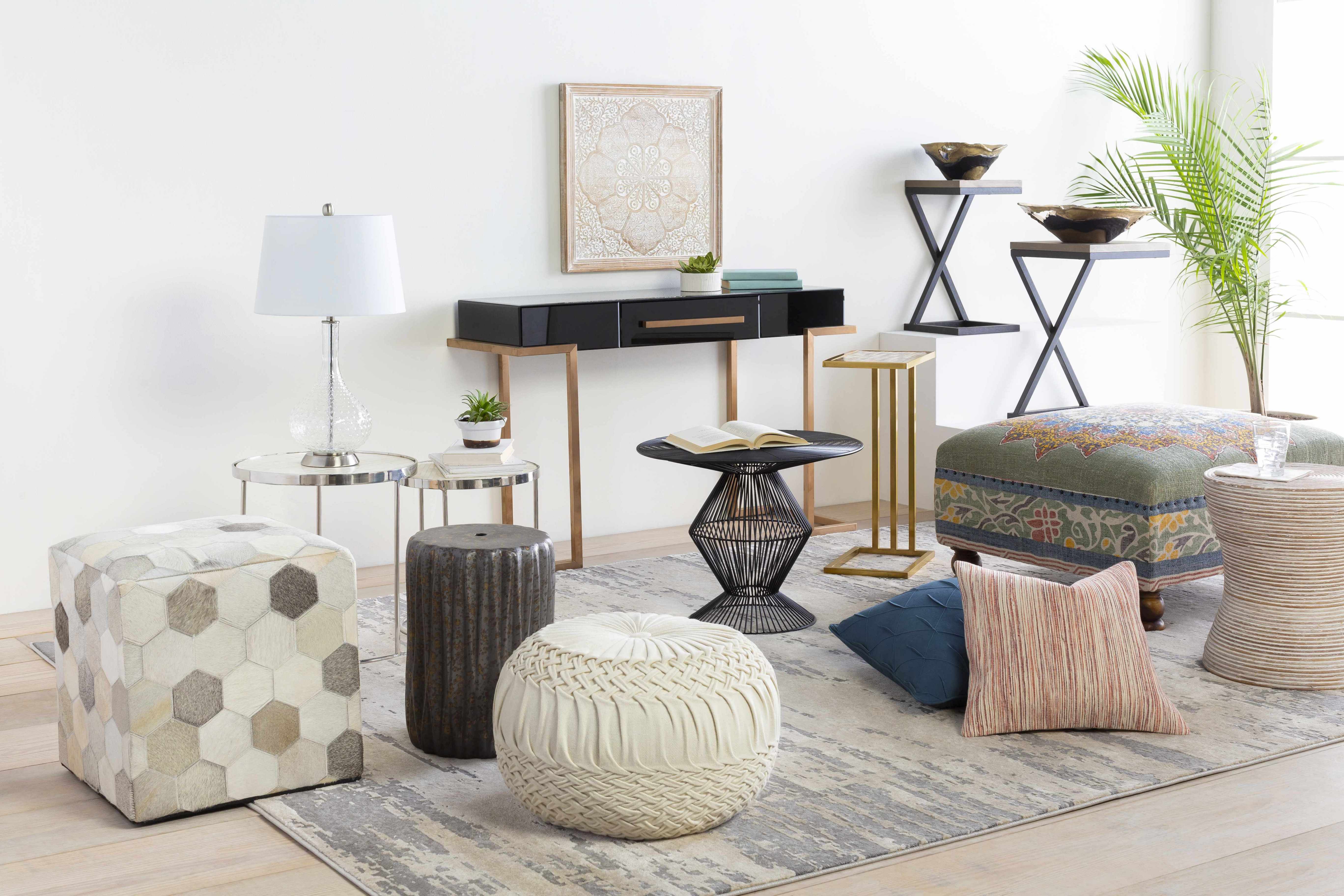 Living room with various furniture pieces including ottomans, side tables, and a rug.