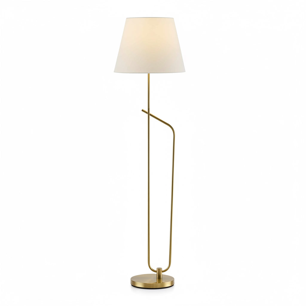 Modern floor lamp with gold base and white shade on a plain background