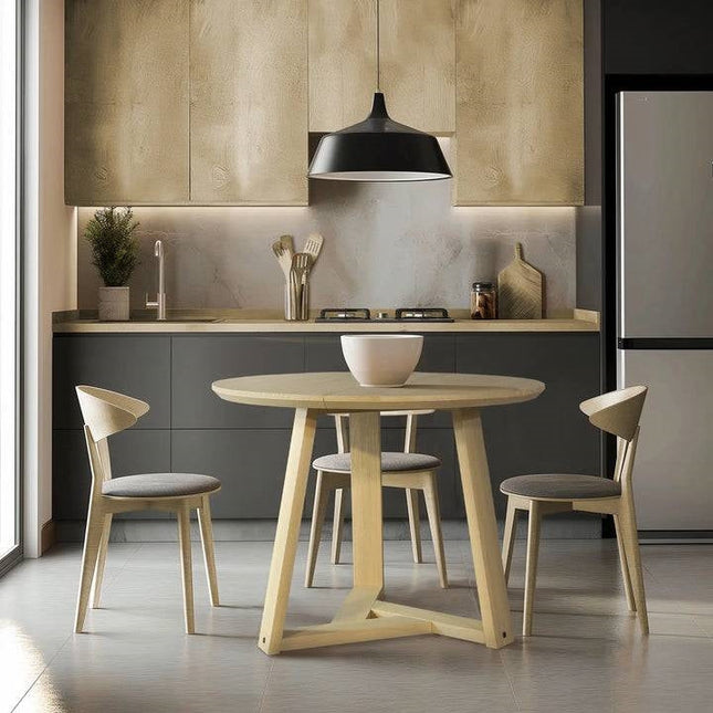Modern kitchen with a round wooden table and chairs.