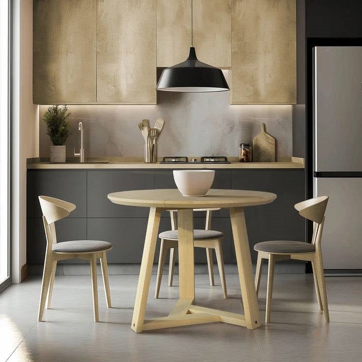 Modern kitchen with a round wooden table and chairs.